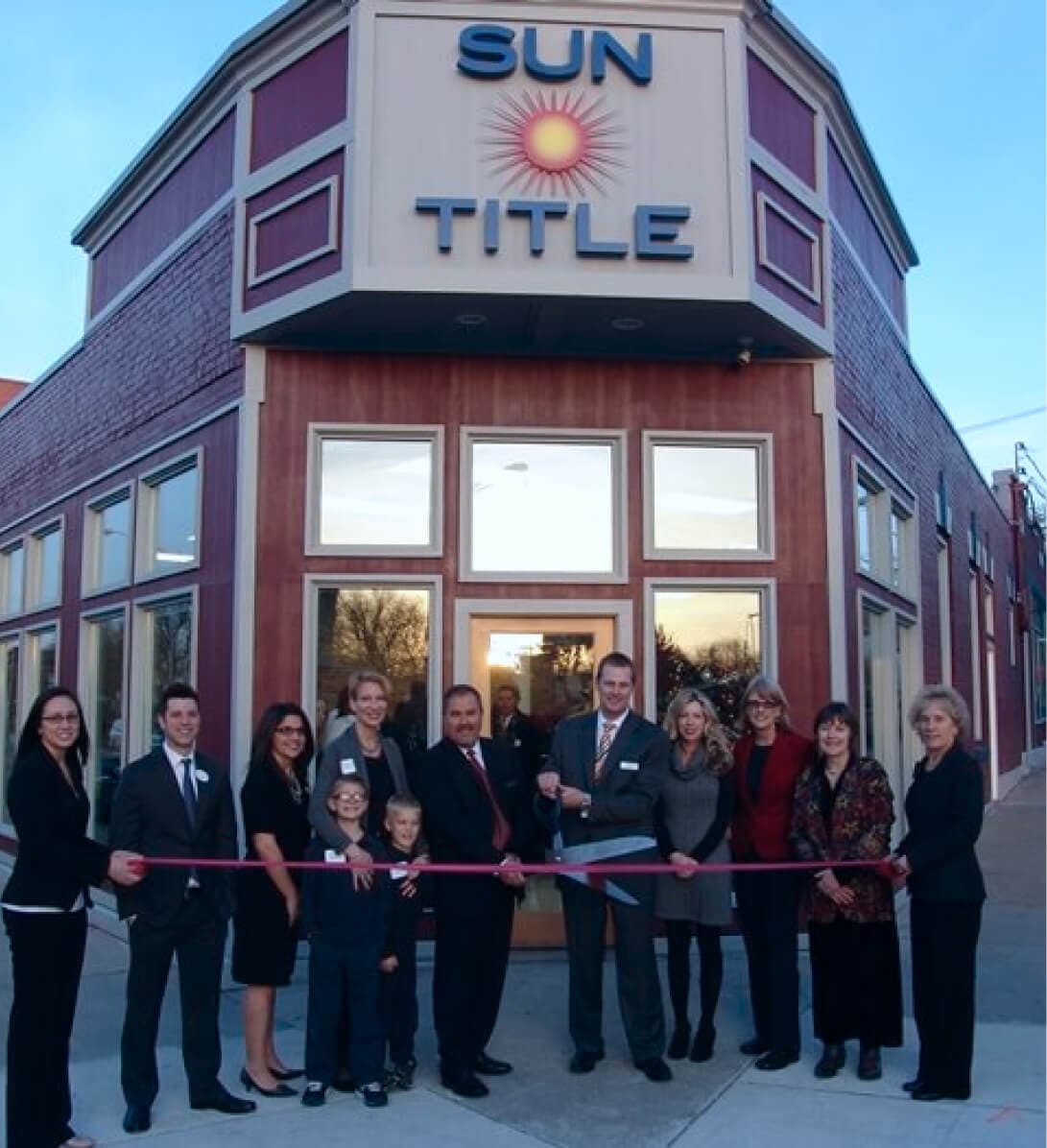 Ribbon-cutting ceremony in front of Sun Title building